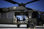 Kentucky Army National Guardsmen wait on board a Sikorsky Aircraft Corp. UH-60 Blackhawk helicopter at the Kentucky State Police Cannabis Suppression Branch headquarters in London, Kentucky, U.S., on Monday, Sept. 14, 2015. Funded by federal grant money, the Kentucky State Troopers and Kentucky Army National Guard work together to enforce marijuana laws including destroying illegal grow operations throughout the state.