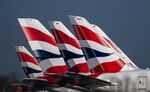 The British Airways livery on the tail fins of passenger aircraft at London Heathrow Airport.