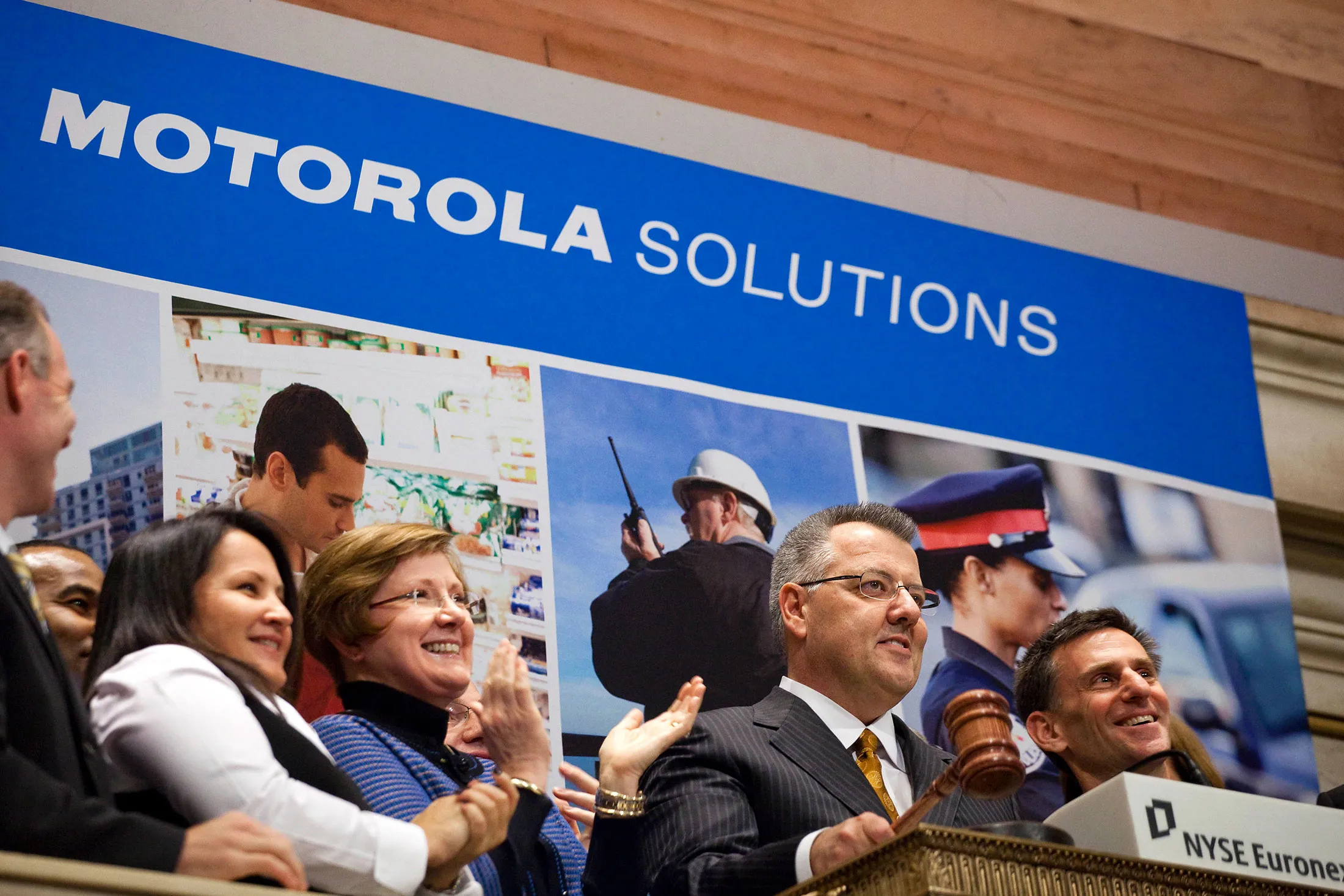 Greg Brown, president and chief executive officer of Motorola Solutions Inc., second from right, rings the closing bell at the New York Stock Exchange in New York on Jan. 4, 2011.
