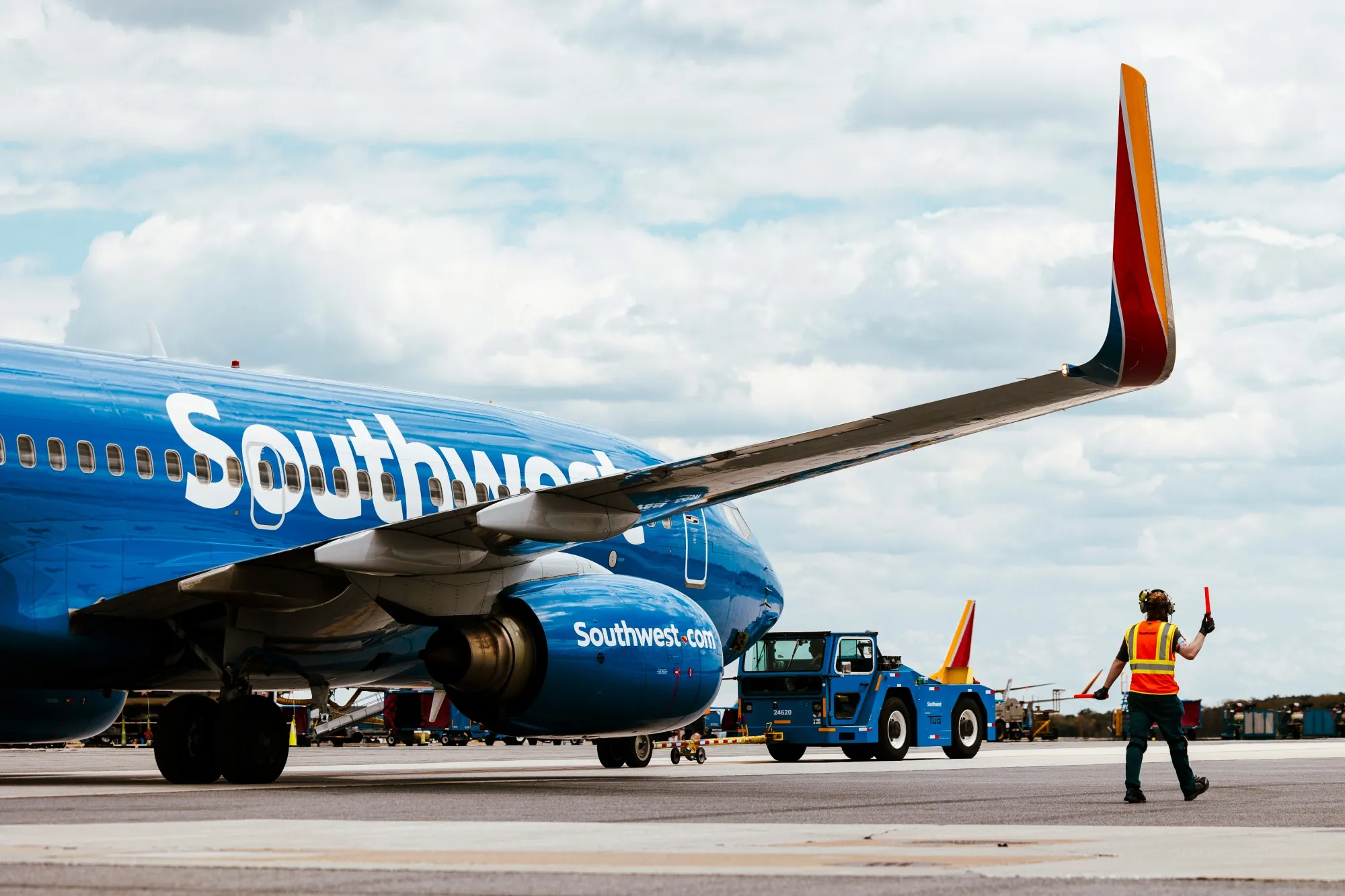 A ramp agents walks under the wing of a Southwest Airlines Boeing 737-700 airplane as it is pushed back from the gate for departure at Baltimore-Washington Airport (BWI) in Baltimore, Maryland.