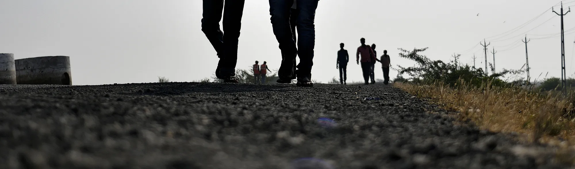 Workers walk along a highway in Dholera.