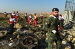 Rescue workers search the wreckage of Ukraine International Airlines Flight 752 which crashed shortly after takeoff near Shahedshahr, Iran, on Jan. 8.