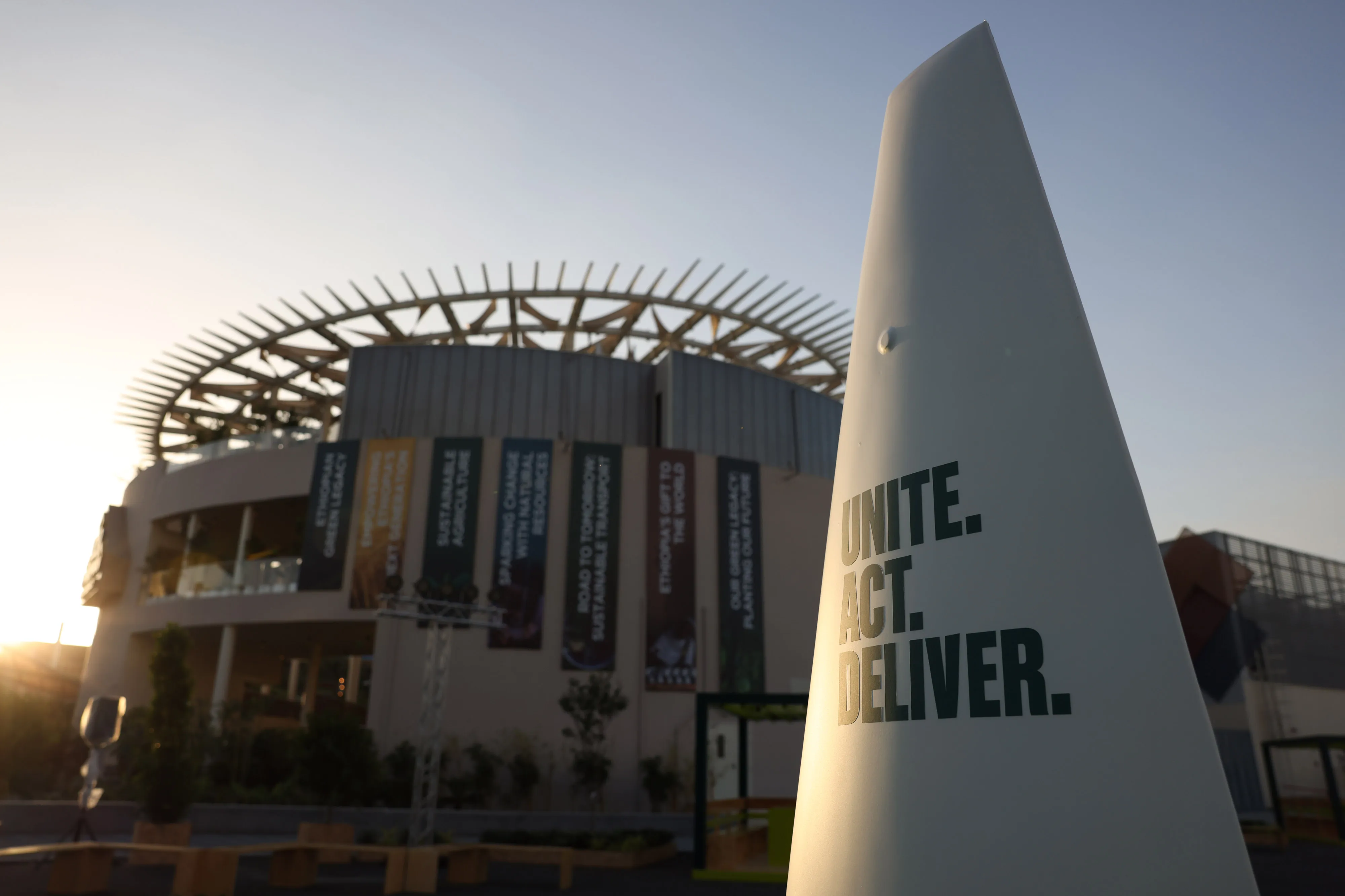 A sign reading 'Unite. Act. Deliver' in the Blue Zone ahead of the COP28 climate conference at Expo City in Dubai, on Nov. 29.