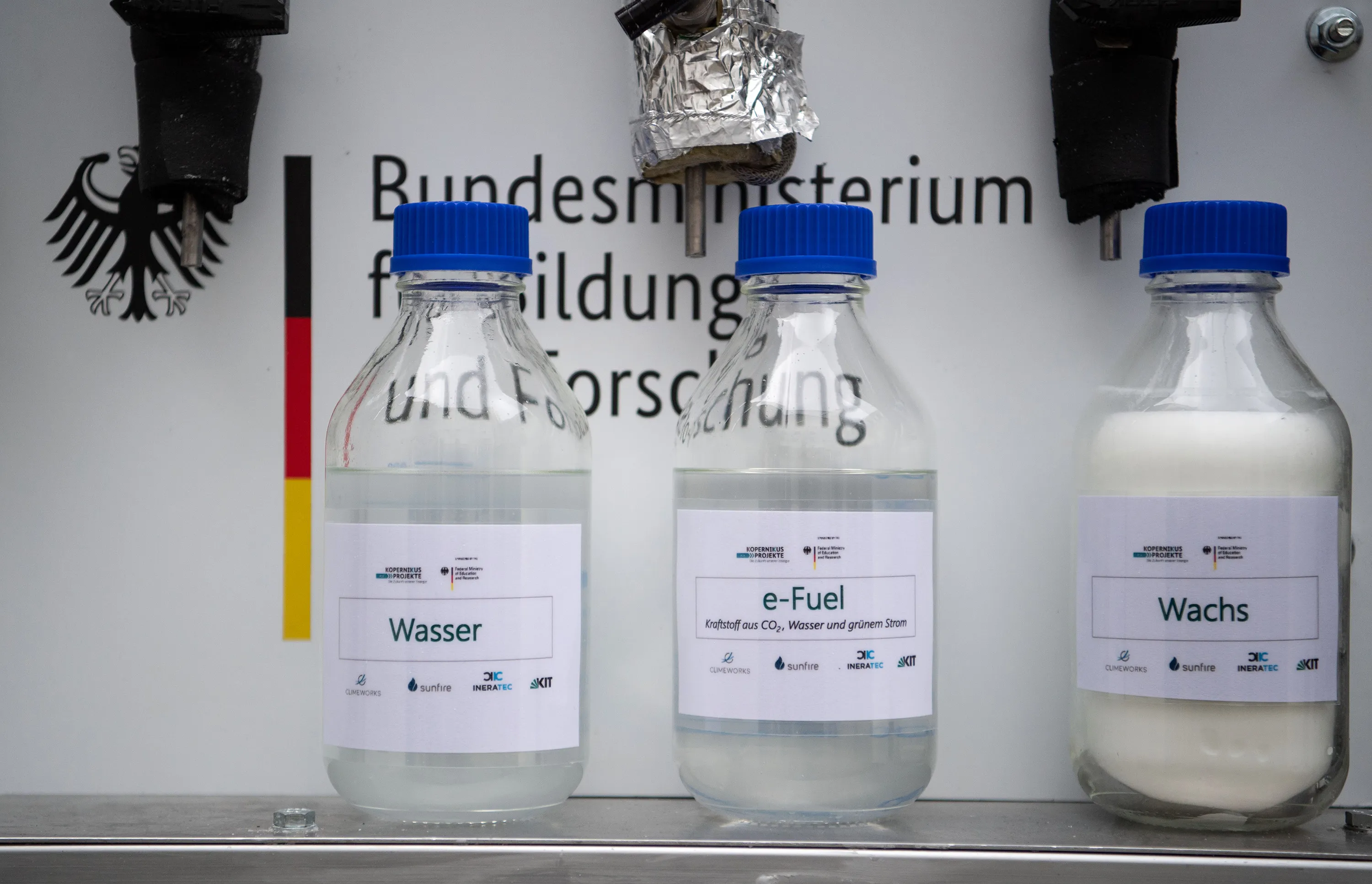 Bottles containing water, e-fuel and synthetic wax using “Power-to-X” technologies.