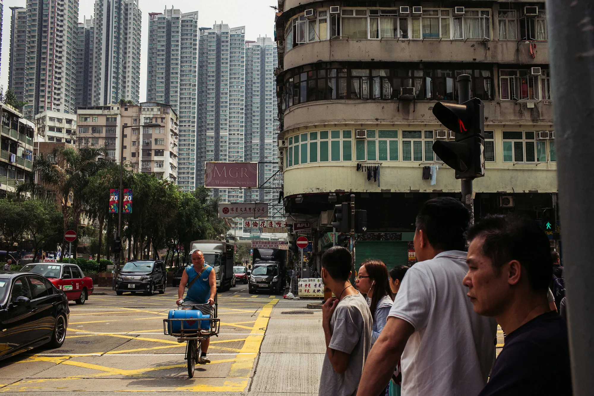 Pedestrians wait to cross a road in the Sham Shui Po district of Hong Kong, China, on April 29, 2017.
