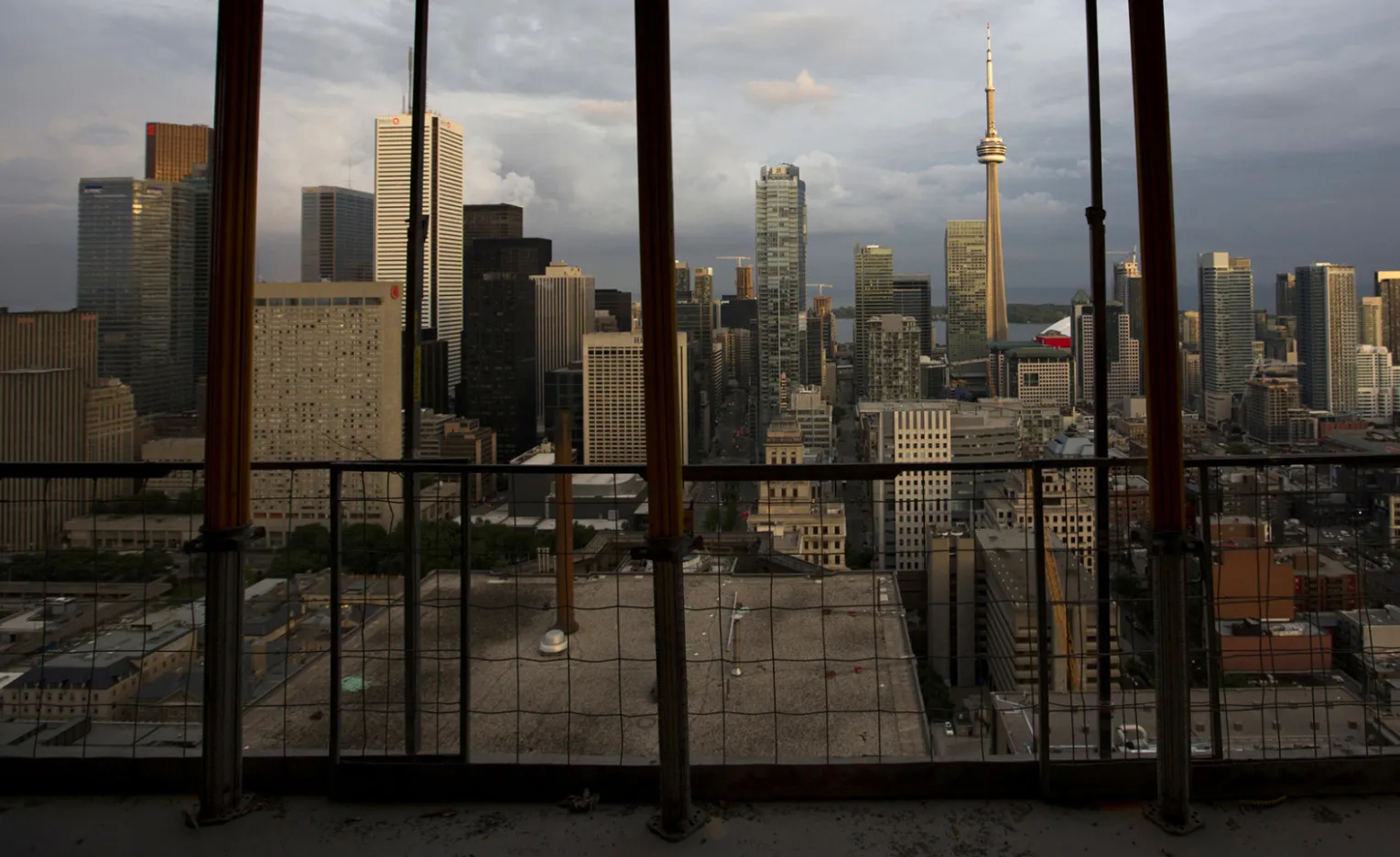 The city skyline is seen from a condominium under construction in Toronto, Ontario, Canada, on Tuesday, June 25 2013. Canada’s housing agency further trimmed its forecast for housing starts this year amid modest economic and employment growth.

