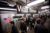 Commuters exit a train at a Wall Street subway station near the New York Stock Exchange (NYSE) in New York, U.S., on Friday, March 16, 2018. U.S. stocks broke out of their four-day slump as traders looked past White House turmoil to reports of better-than-expected factory output, which pushed 10-year Treasury yields higher and helped the dollar erase losses.