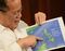 Philippine President Benigno Aquino points to a copy of China's nine-dash line map during an interview with AFP at Malacanang Palace in Manila on April 14, 2015. China's efforts to stake its claim to most of the South China Sea should spark fear around the world, Aquino told AFP on April 14. AFP PHOTO/TED ALJIBE (Photo credit should read TED ALJIBE/AFP/Getty Images)