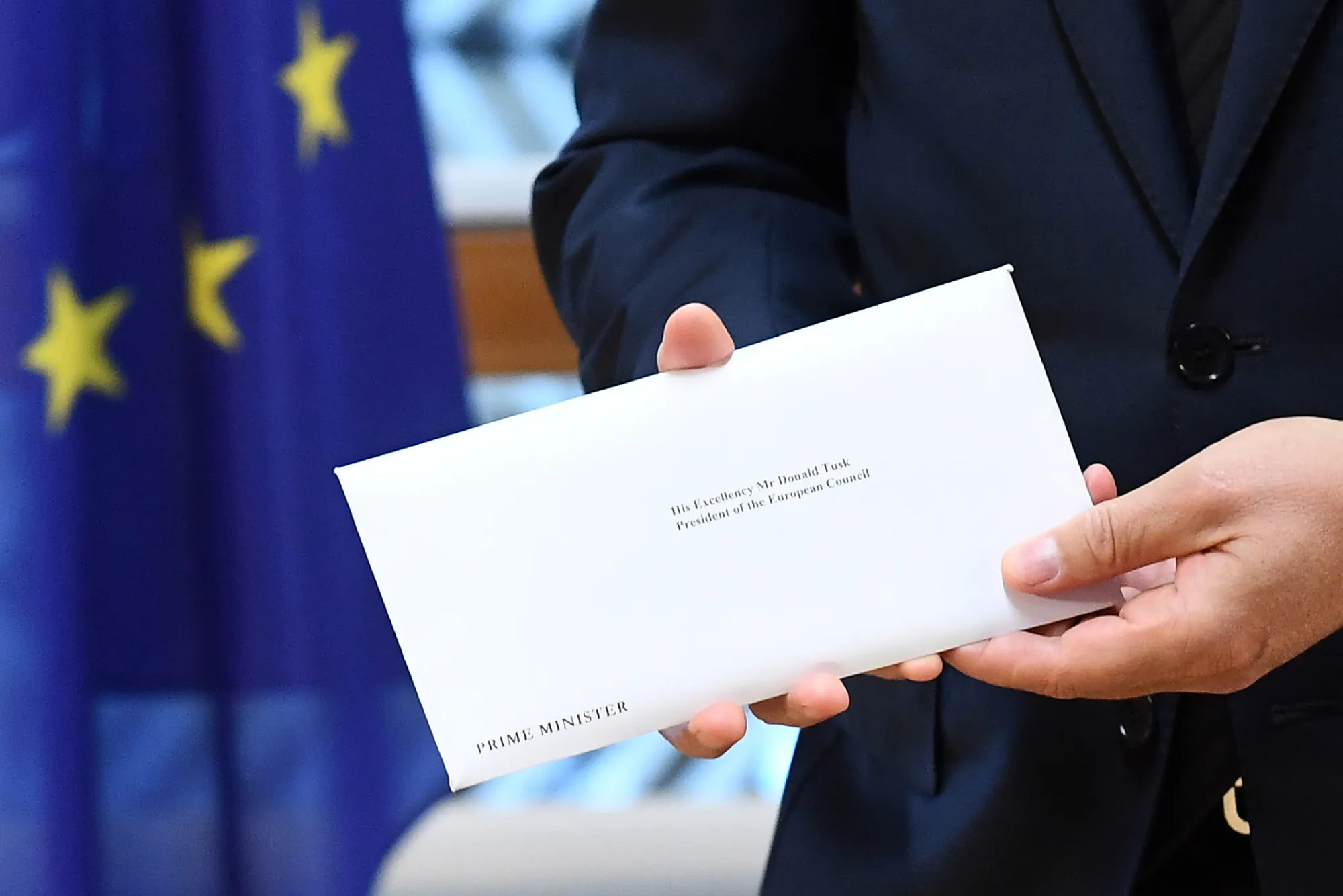 Britain's ambassador to the EU Tim Barrow delivers the formal notice of the UK's intention to leave the bloc under Article 50 to European Council President Donald Tusk in Brussels on March 29.
