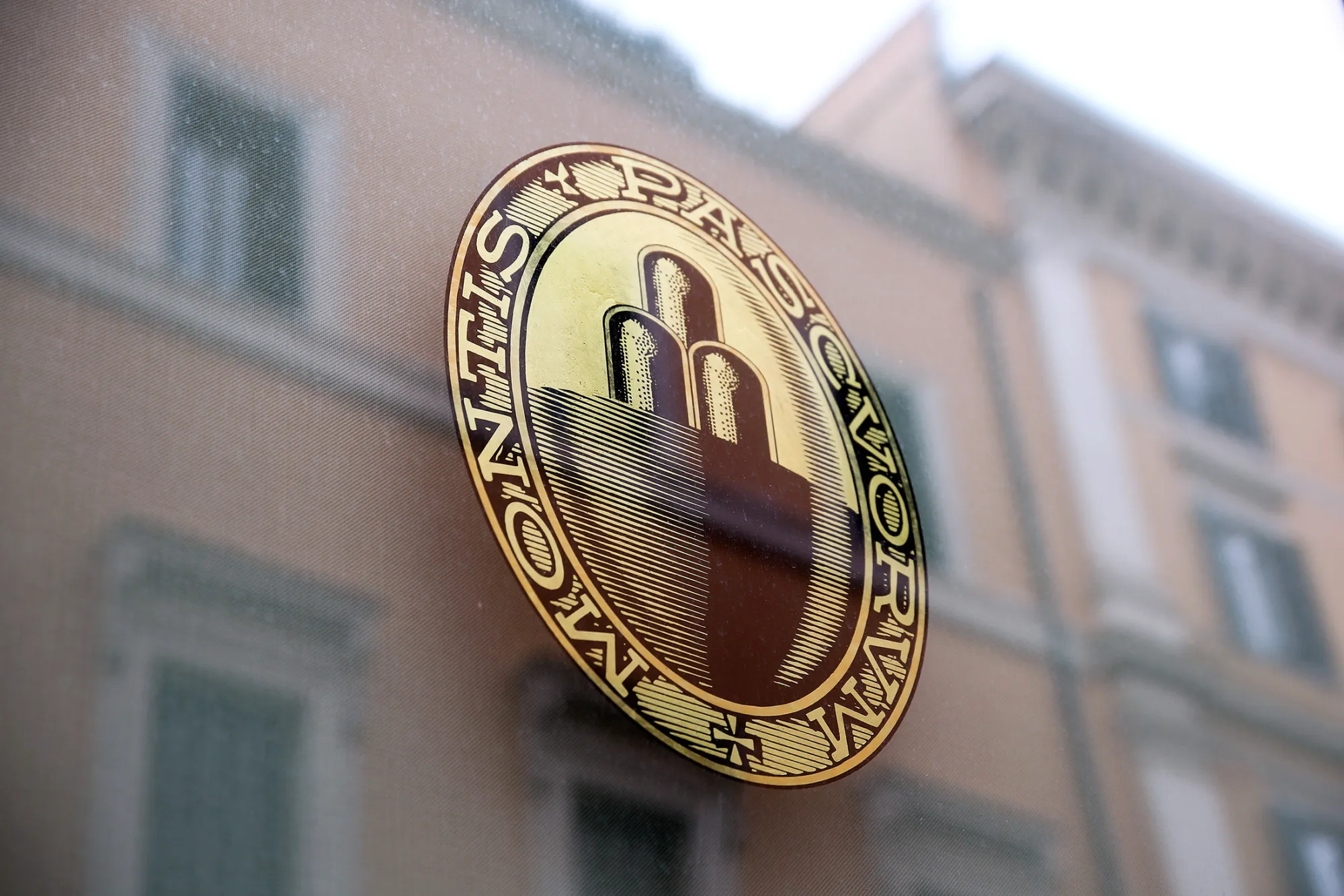 The Banca Monte dei Paschi di Siena SpA's logo sits on a window at one of the company's bank branches in Rome, Italy, on Wednesday, Jan. 27, 2016. Italy's banking woes are set to plague Prime Minister Matteo Renzi for months to come after a long-sought deal with the European Union on bad debts disappointed investors.
