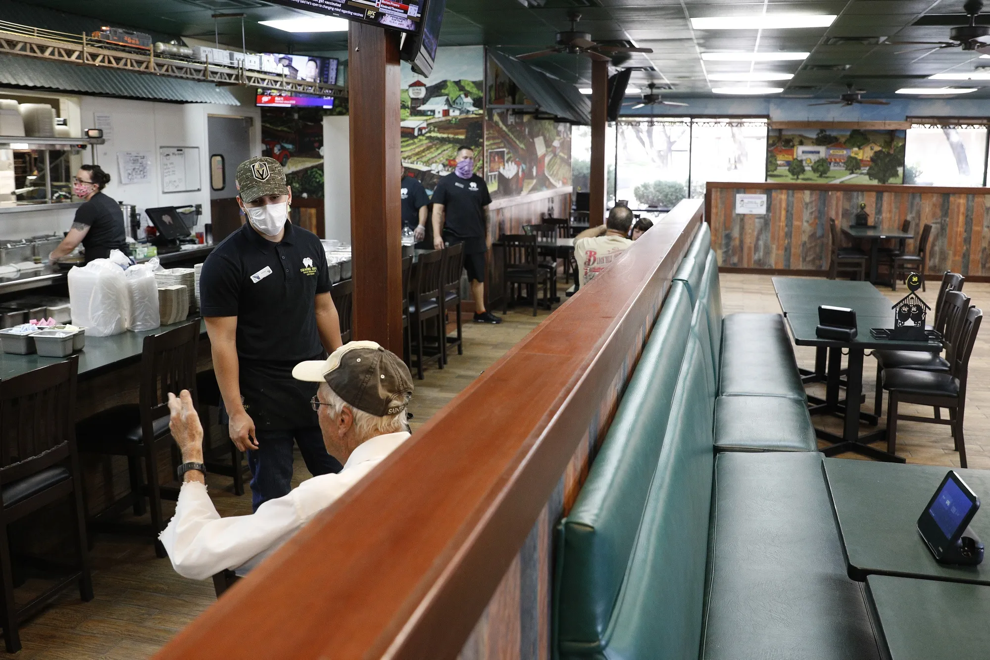 An employee speaks with a customer at a restaurant in Las Vegas on May 9.