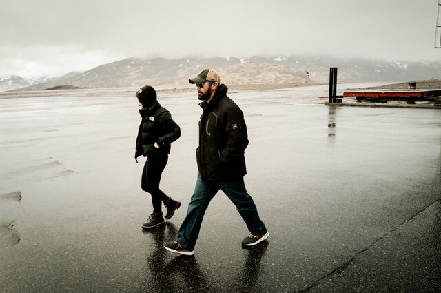 Horn walks to the helicopter that carried him above the site.