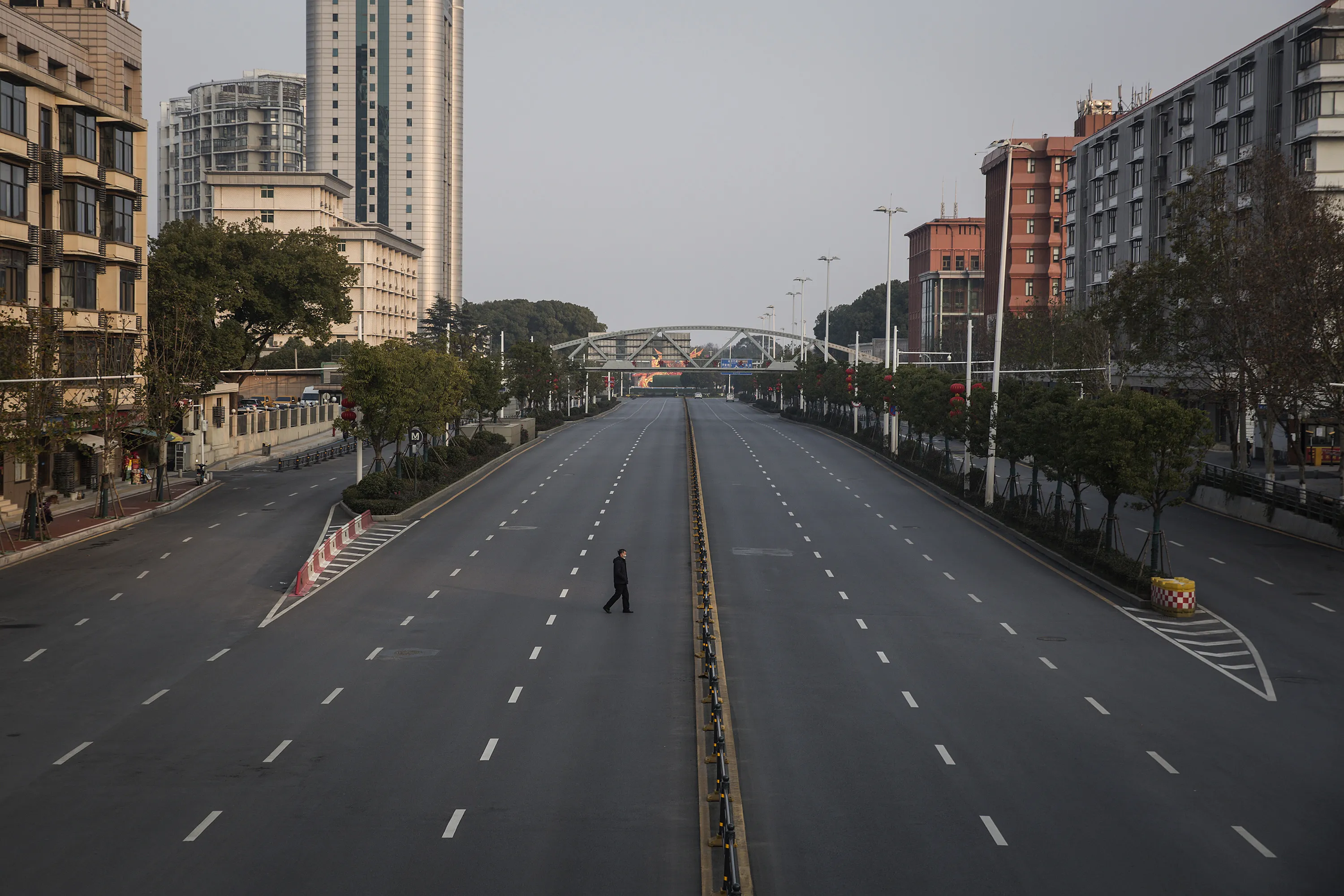 A man crosses an empty highway road&nbsp;in Wuhan, China.&nbsp;