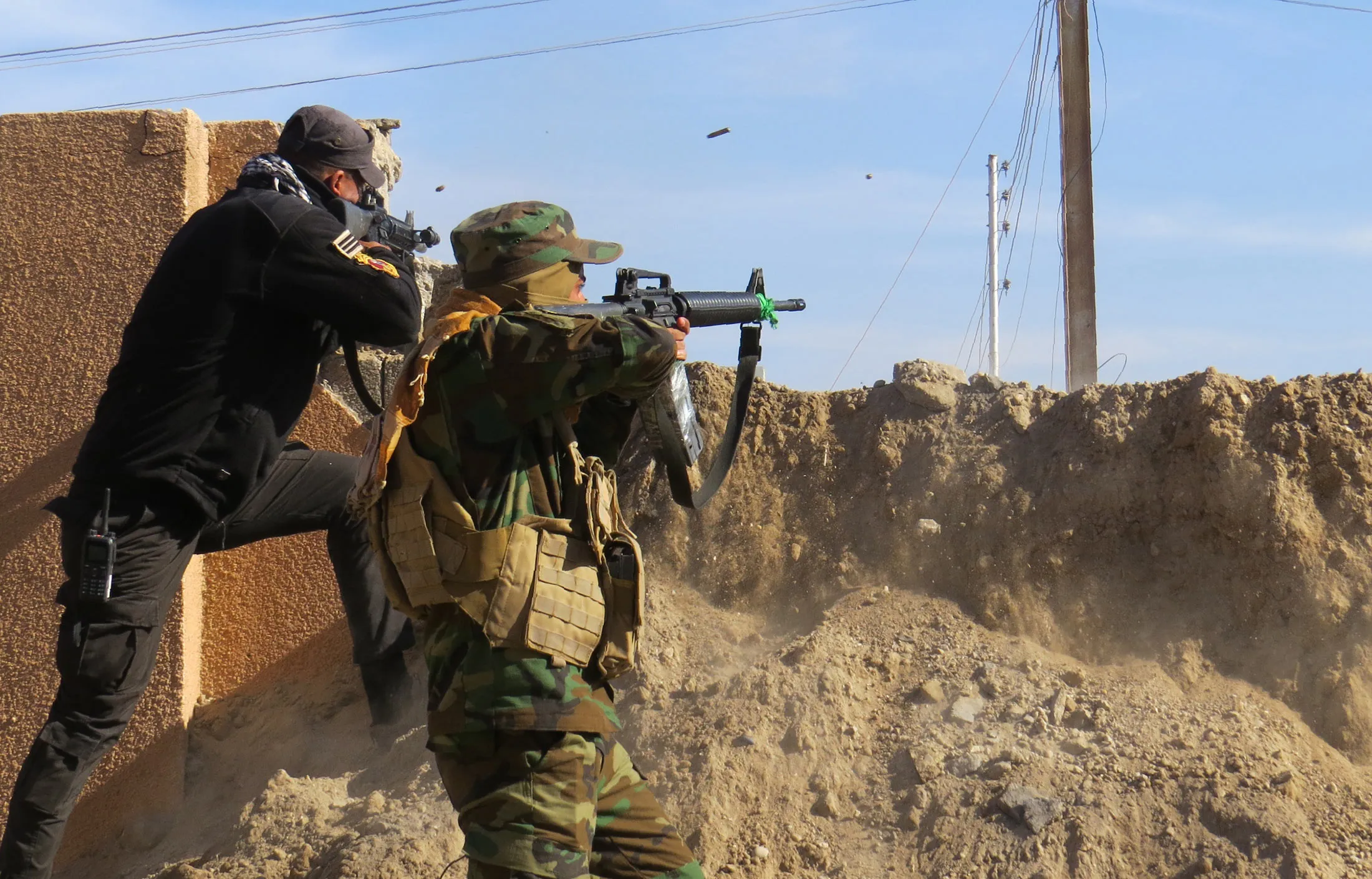Members of the Iraqi government forces battle with Islamic State (IS) group fighters east of Ramadi, after they took control of the agricultural area surrounding the eastern part of the capital of Iraq's Anbar province on Jan. 12, 2016.
