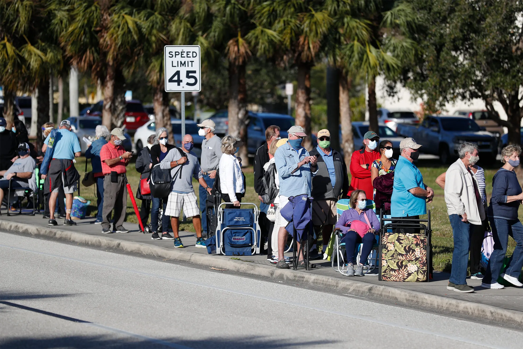 Seniors and first responders wait in line for vaccines in Fort Myers, Fla., on Dec. 30, 2020.