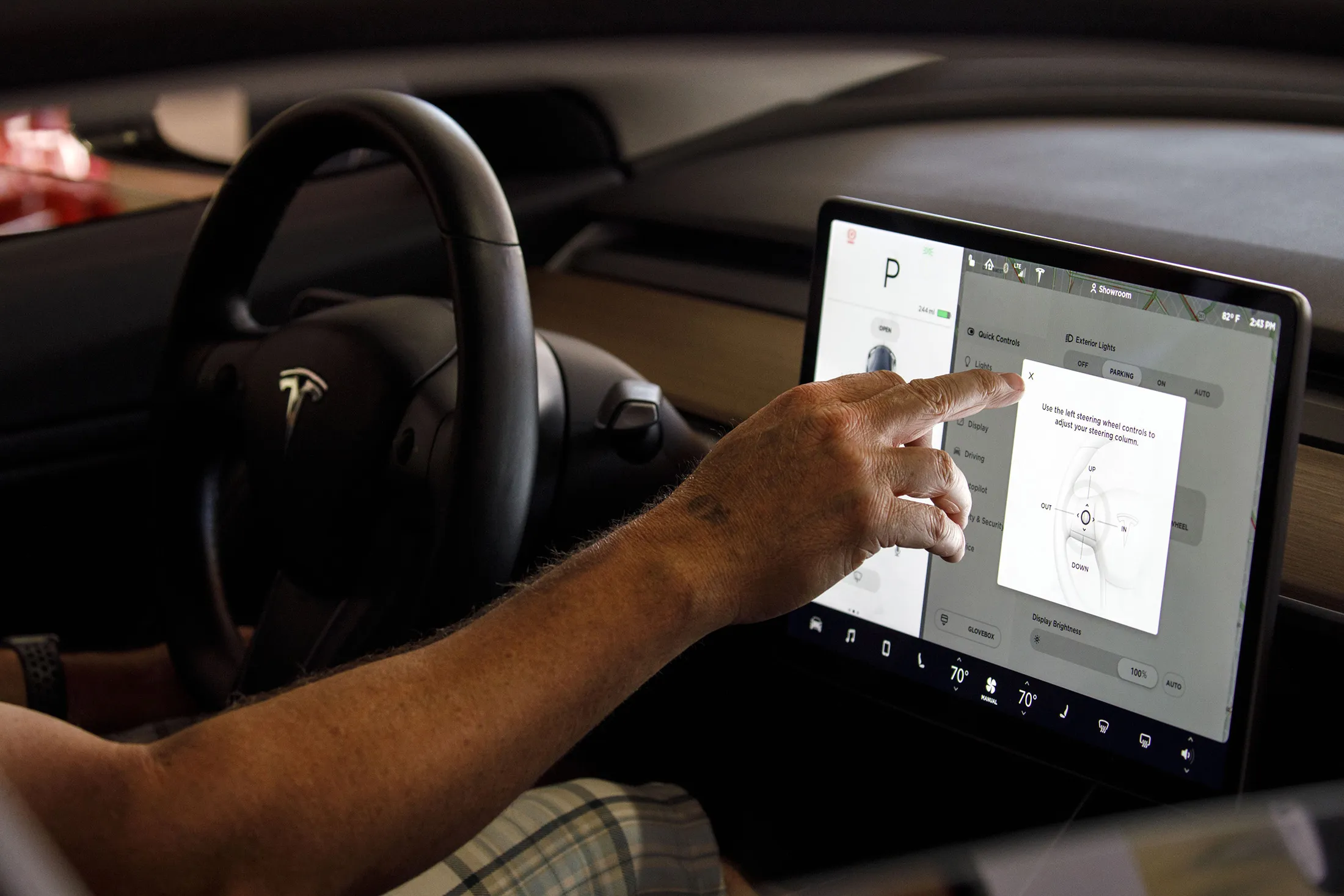 A customer uses the touch screen display in a Tesla Inc. Model 3 electric vehicle.