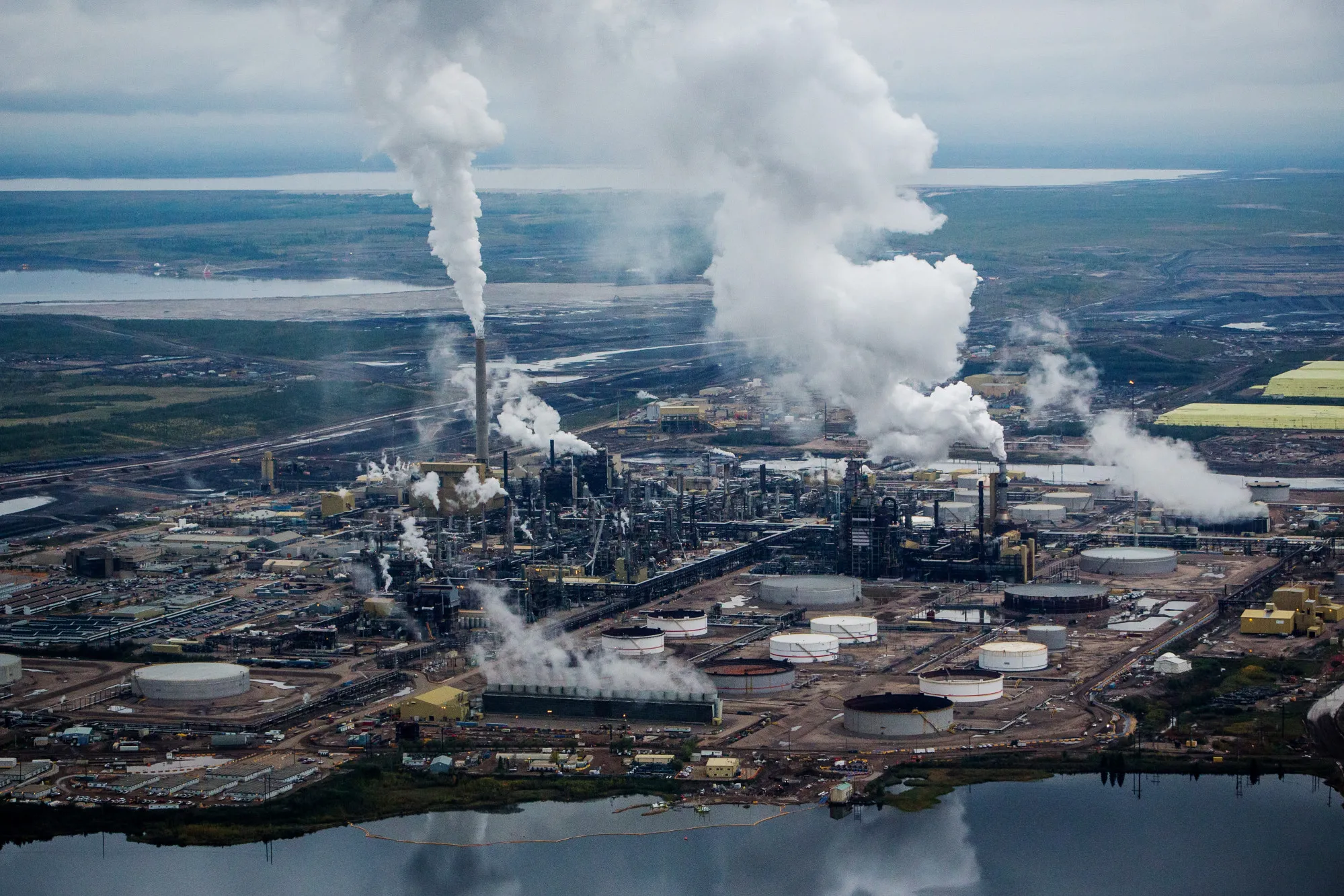 Steam rises from an upgrader plant in the Athabasca oil sands near Fort McMurray, Alberta.