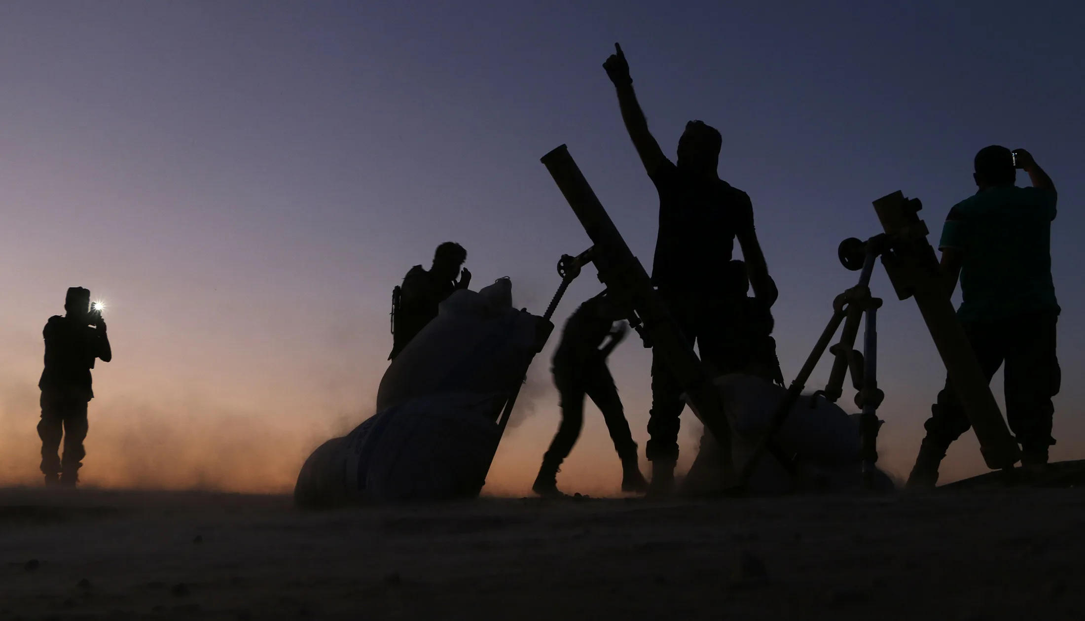 Fighters from the Free Syrian Army cheer and react as they fight against the Islamic State (IS) group jihadists on the outskirts of the northern Syrian town of Dabiq, on October 15, 2016. Turkish-backed fighters were advancing on the northern Syrian town of Dabiq, which has become a rallying cry for the Islamic State group as the prophesied scene of an end-of-days battle. Dabiq holds crucial ideological importance for IS because of a Sunni prophecy that states it will be the site of an end-of-times battle between Christian forces and Muslims. / AFP / Nazeer al-Khatib (Photo credit should read NAZEER AL-KHATIB/AFP/Getty Images)
