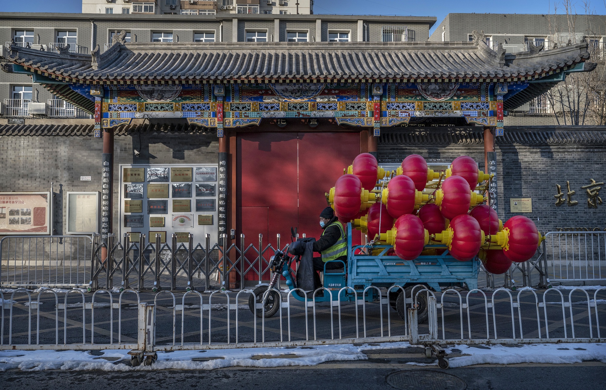 A worker carries red lanterns to be hung from streetlights ahead of Lunar New Year in Beijing on Jan. 27.
