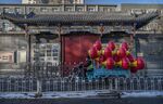 A worker carries red lanterns to be hung from streetlights ahead of Lunar New Year in Beijing on Jan. 27.