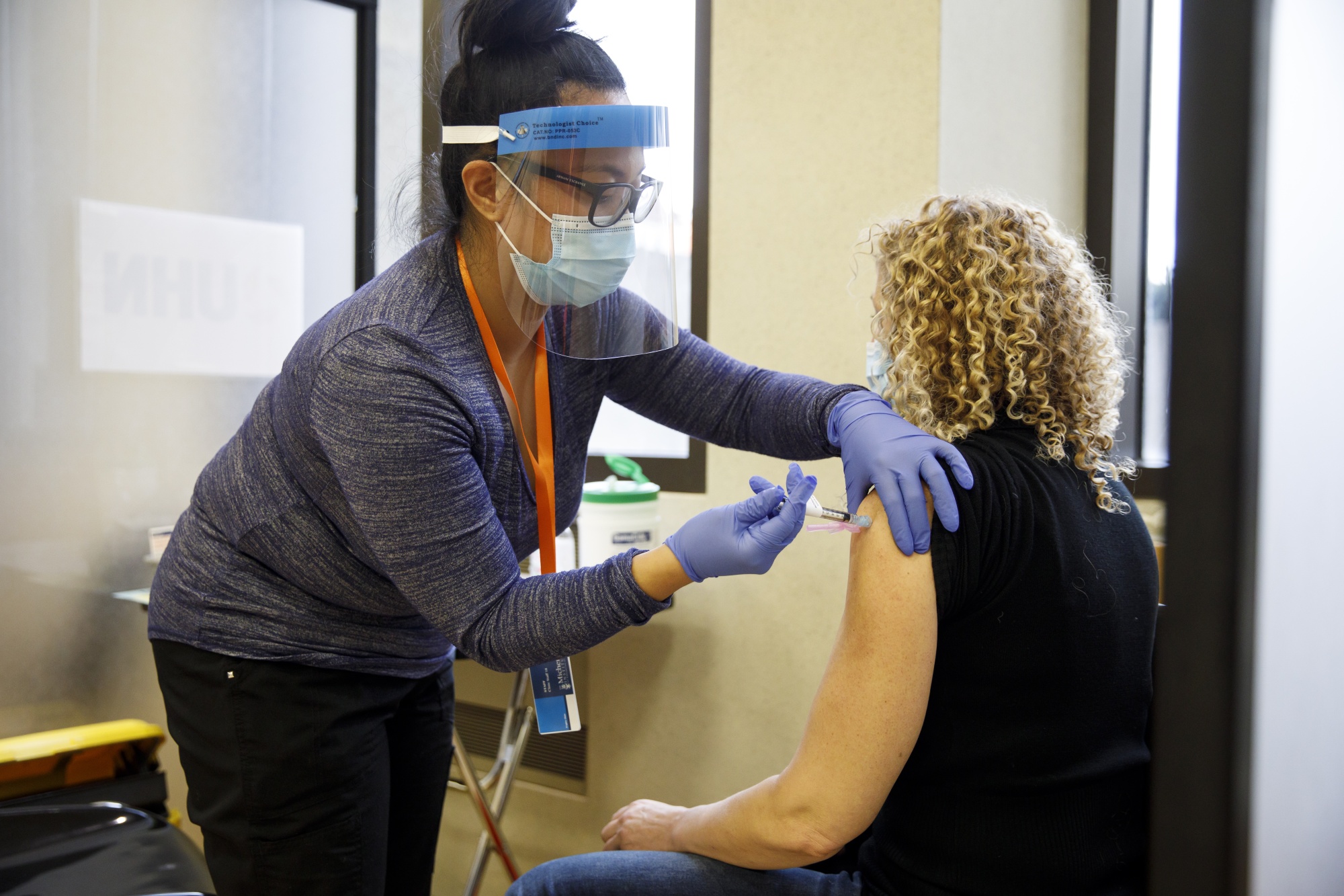 A healthcare worker receives the Pfizer-BioNTech Covid-19 vaccine at a Toronto clinic on Dec. 15, 2020.