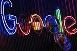 The Google Inc. logo hangs illuminated at the company's exhibition stand at a digital marketing conference in Cologne, Germany, on Wednesday, Sept. 14, 2016. Dmexco is a two-day global business and digital economy innovation platform, attracting the industry's most important personalities and corporate decision-makers.
