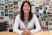 Ellen Pao, head of business strategy for the web-based community message board Reddit, in front of a wall of postcards sent in by users at the company's offices in San Francisco, on July 16, 2014.

