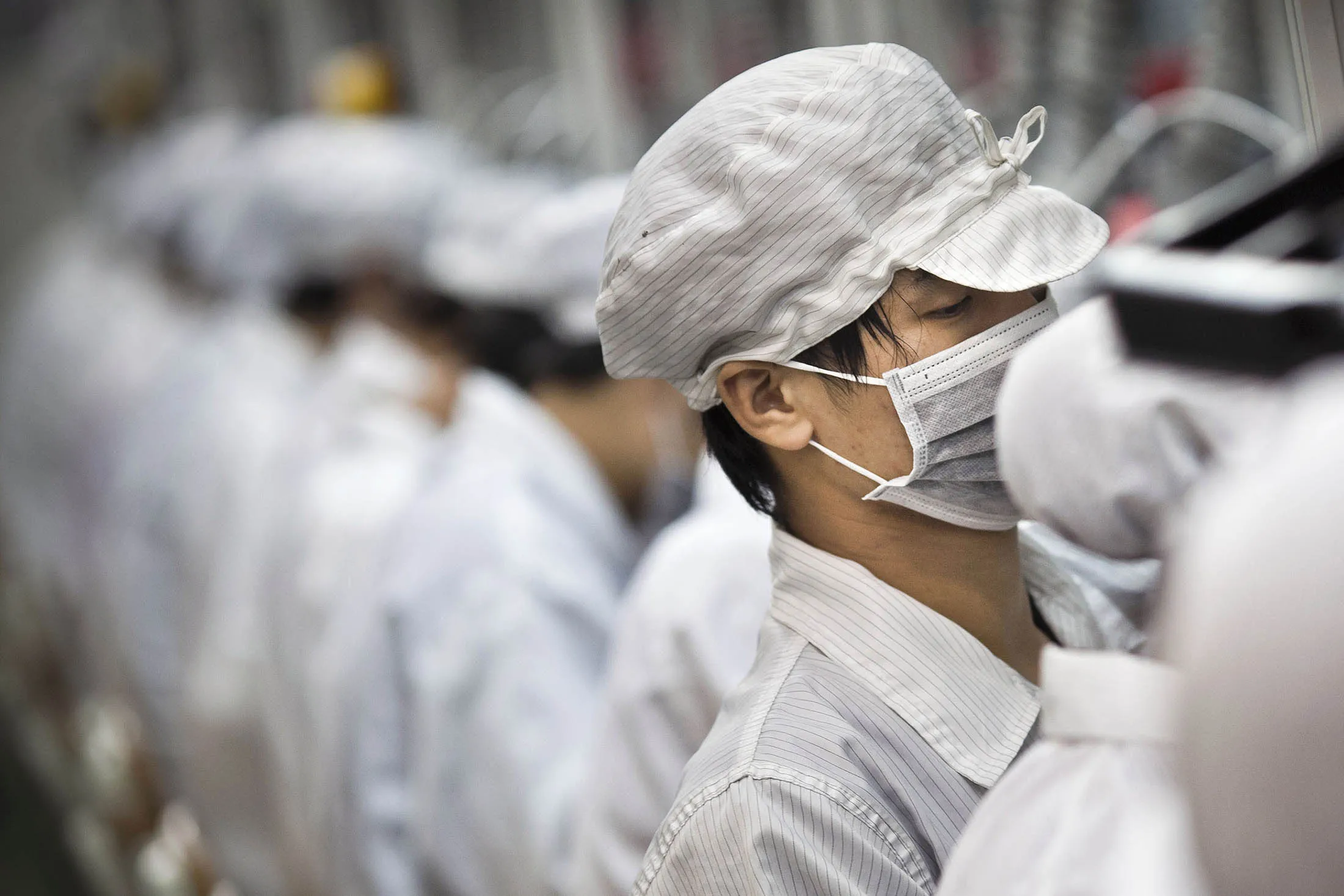 Foxconn employees work along a production line in in Shenzhen, China.
