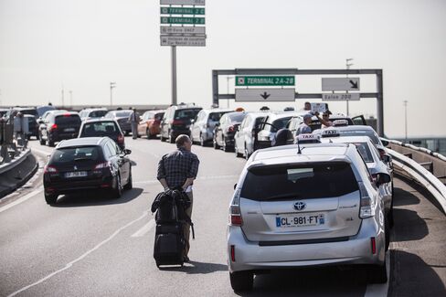 A row of French taxis outside Charles de Gaulle Airport protesting against Uber’s ride-hailing service.