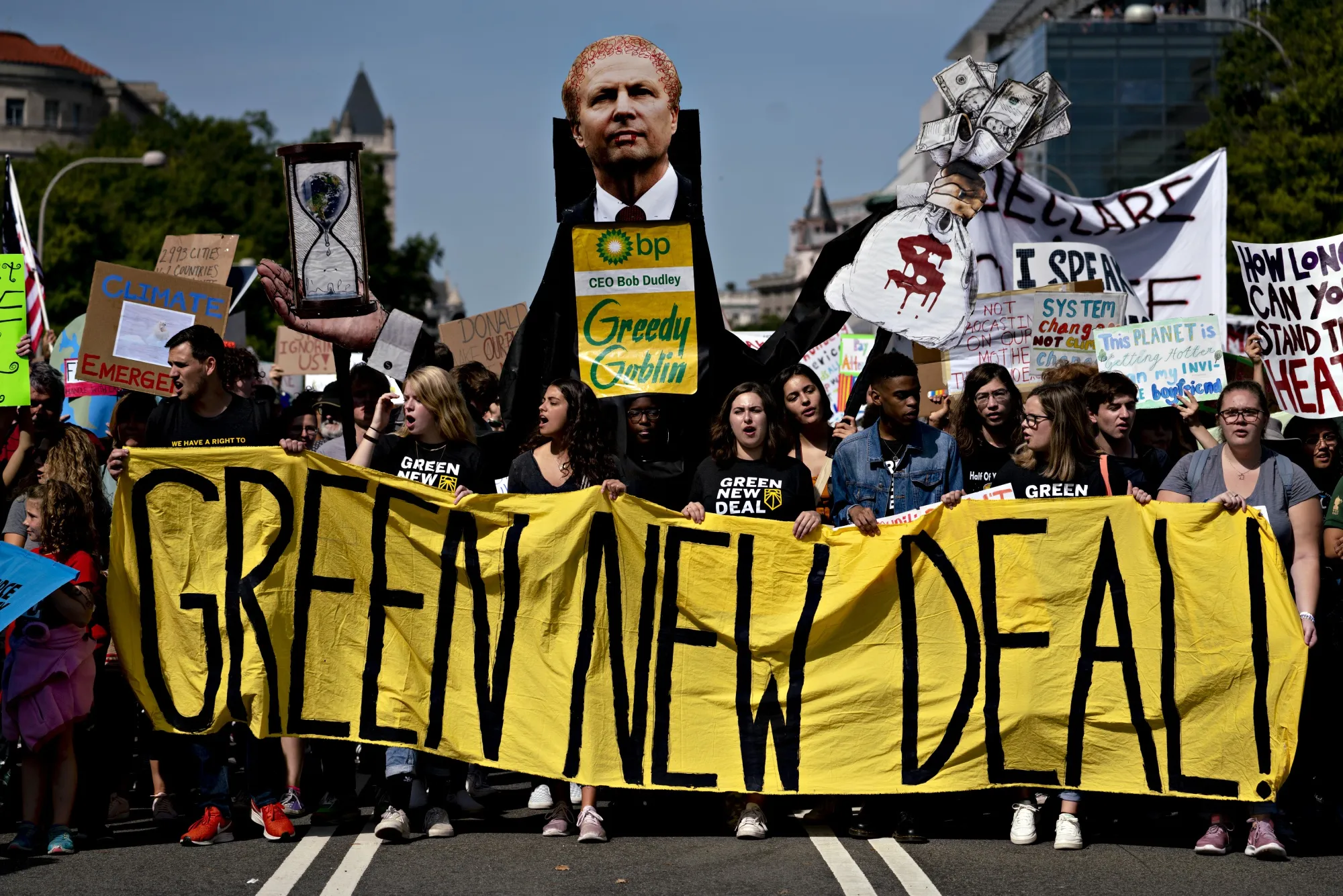 Protesters hold a 'Green New Deal!' sign during the Global Climate Strike demonstration in Washington, D.C., U.S., on Friday, Sept. 20, 2019.&nbsp;