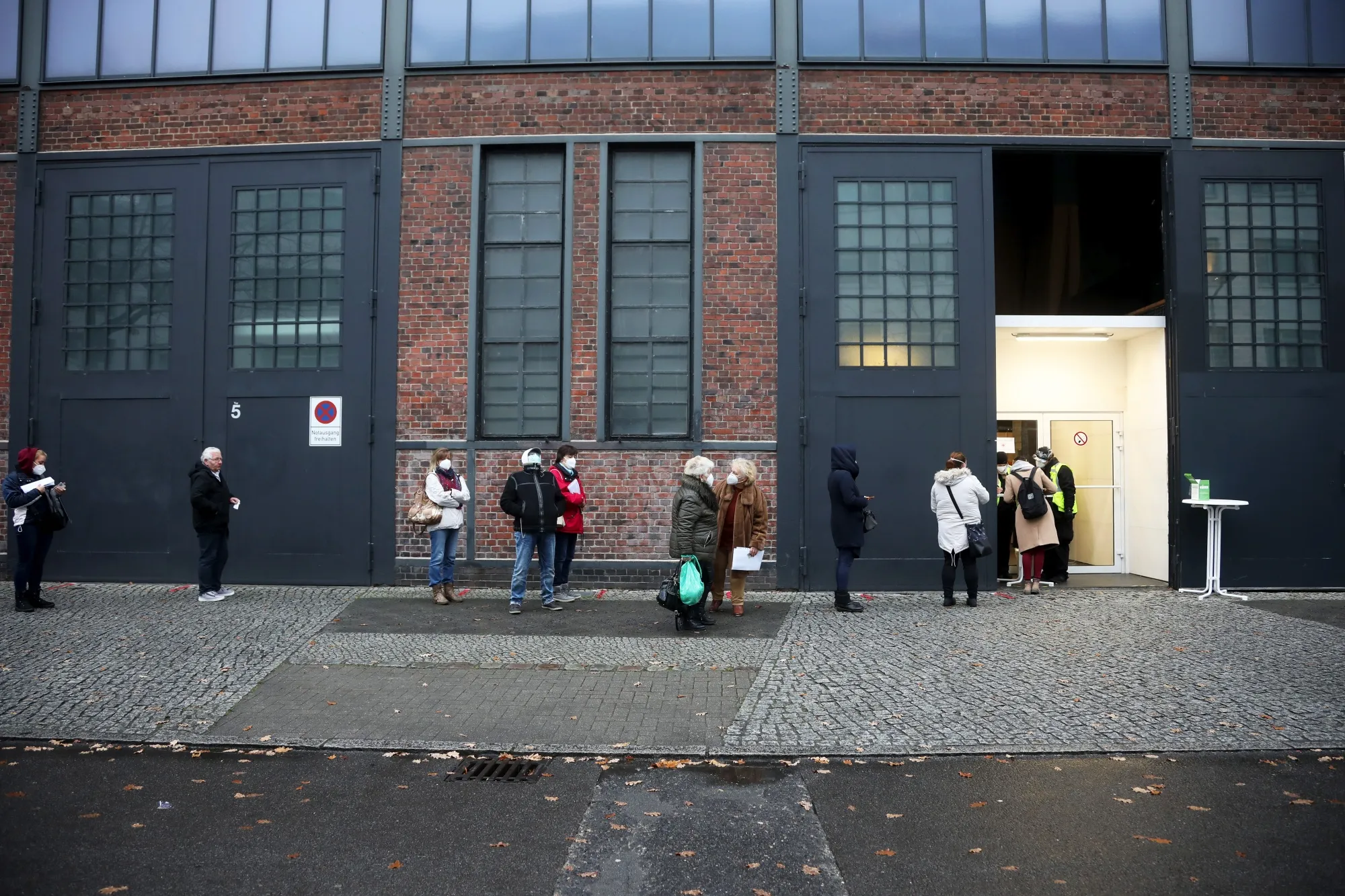Visitors queue outside a Covid-19 vaccination site at Berlin Arena in Berlin, on Jan. 4.