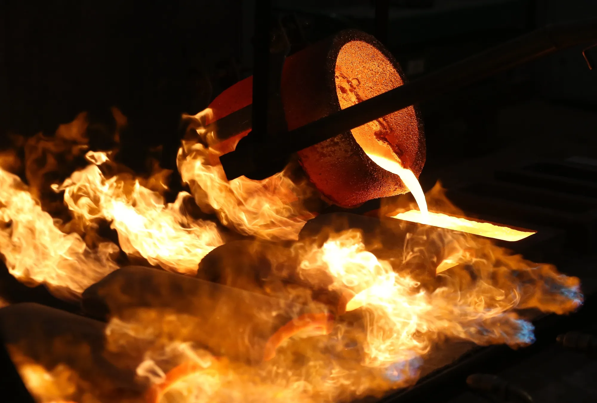 Molten gold pours from a crucible into a mold during the casting of ingots at a foundry in Krasnoyarsk, Russia.