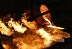 Molten gold pours from a crucible into a mold during the casting of ingots at a foundry in Krasnoyarsk, Russia.