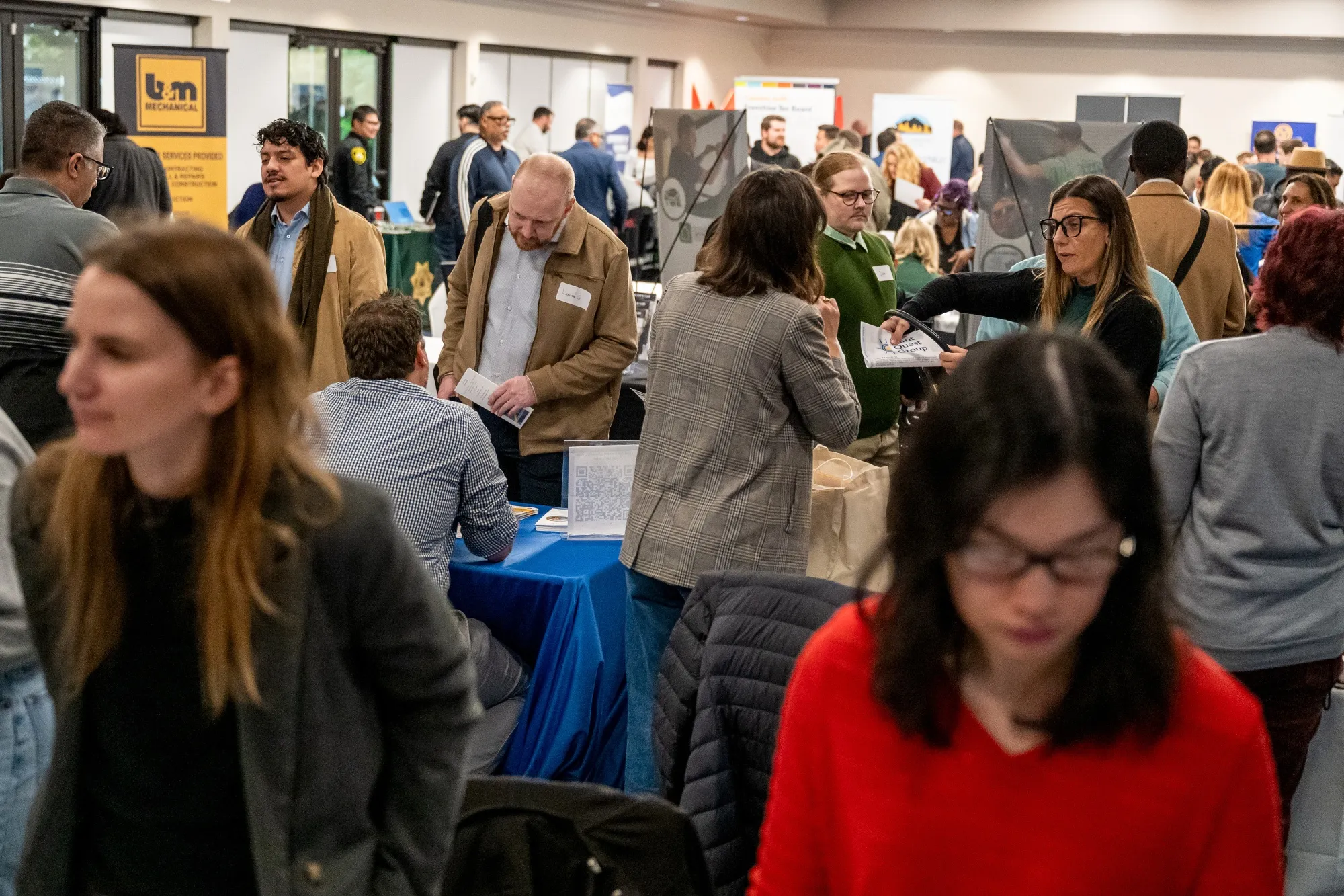 Job seekers speak with recruiters during a job fair in Sacramento, California.