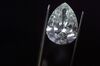 A finished pear-shaped diamond is displayed by an employee using tweezers in this arranged photograph at the Shrenuj Botswana Ltd. sightholder office in Gaborone, Botswana.