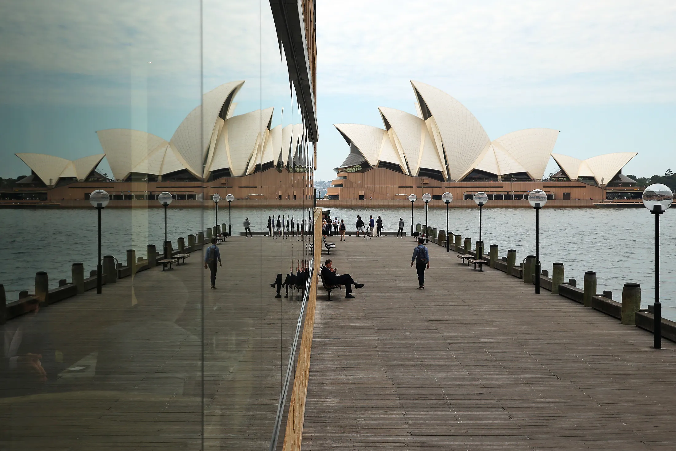 A reflection of the Sydney Opera House is seen in a window in Sydney.
