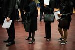 Job seekers wait in line to speak with representatives during a Choice Career Fair in New York.