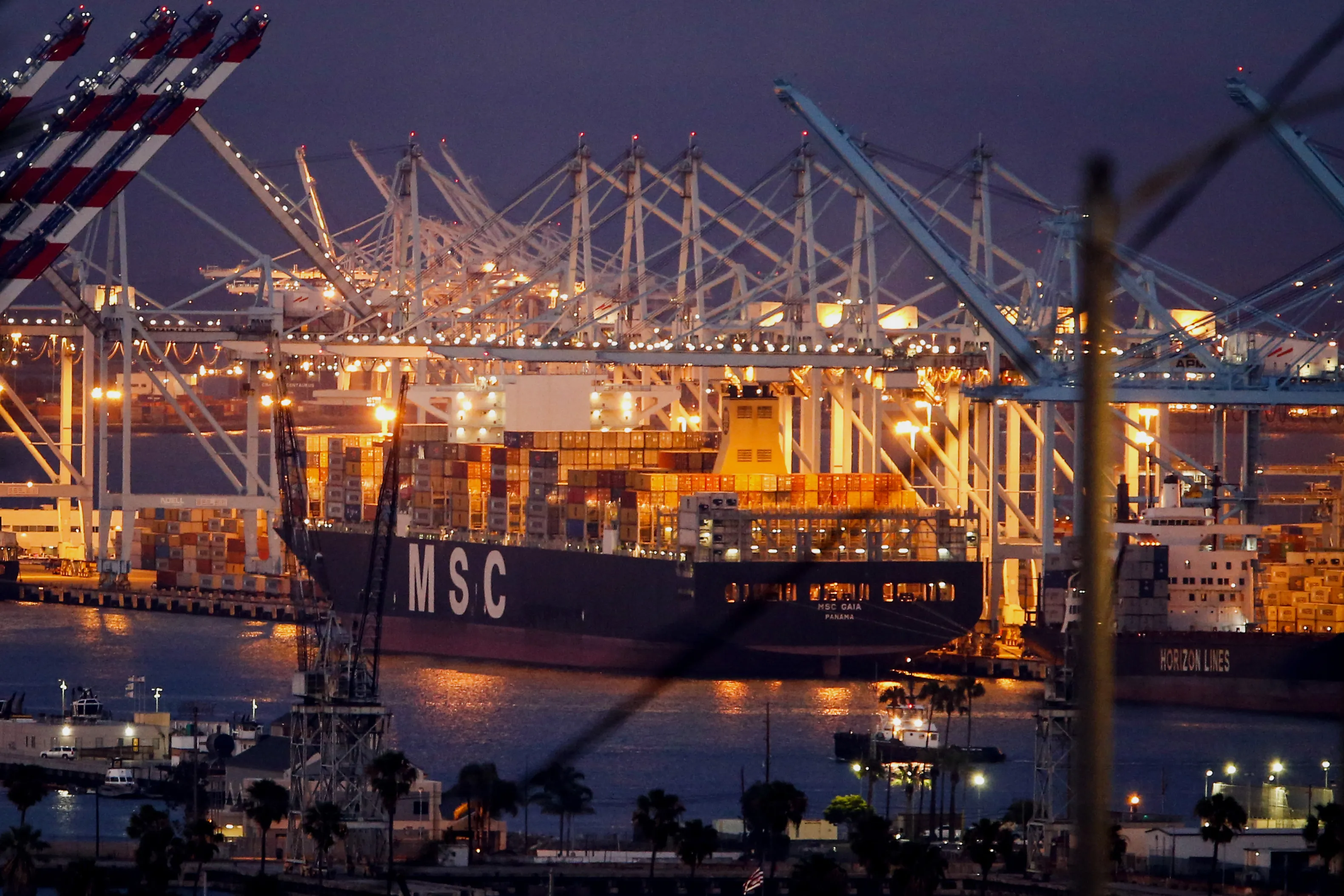 The MSC Gaia ship sits docked as cranes load and unload containers at the Port of Los Angeles in Los Angeles, California, U.S., on Thursday, June 11, 2015. President Barack Obama made a rare trip to Capitol Hill Friday to press fellow Democrats to back his trade agenda, a key second-term priority, in a sign that his own party may scuttle a vote on fast-track negotiating authority.