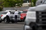 Customers view a vehicle for sale at a Ford Motor Co. dealership in Richmond, California, U.S., on Thursday, July 1, 2021.