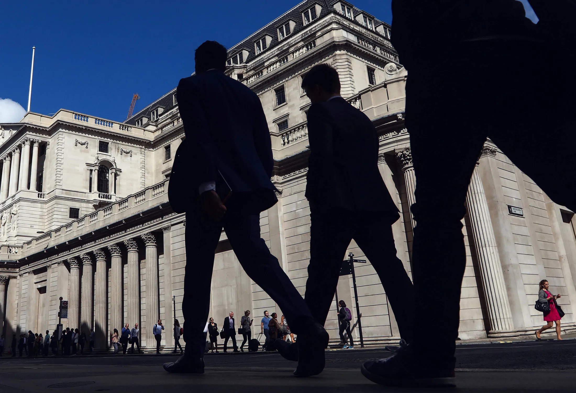Pedestrians walk past the Bank of England (BOE) in the City of London, U.K., on Thursday, July 14, 2016.
