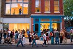 People gather in the street near an open gallery in Philadelphia's Old City neighborhood for a &quot;First Friday&quot; event.