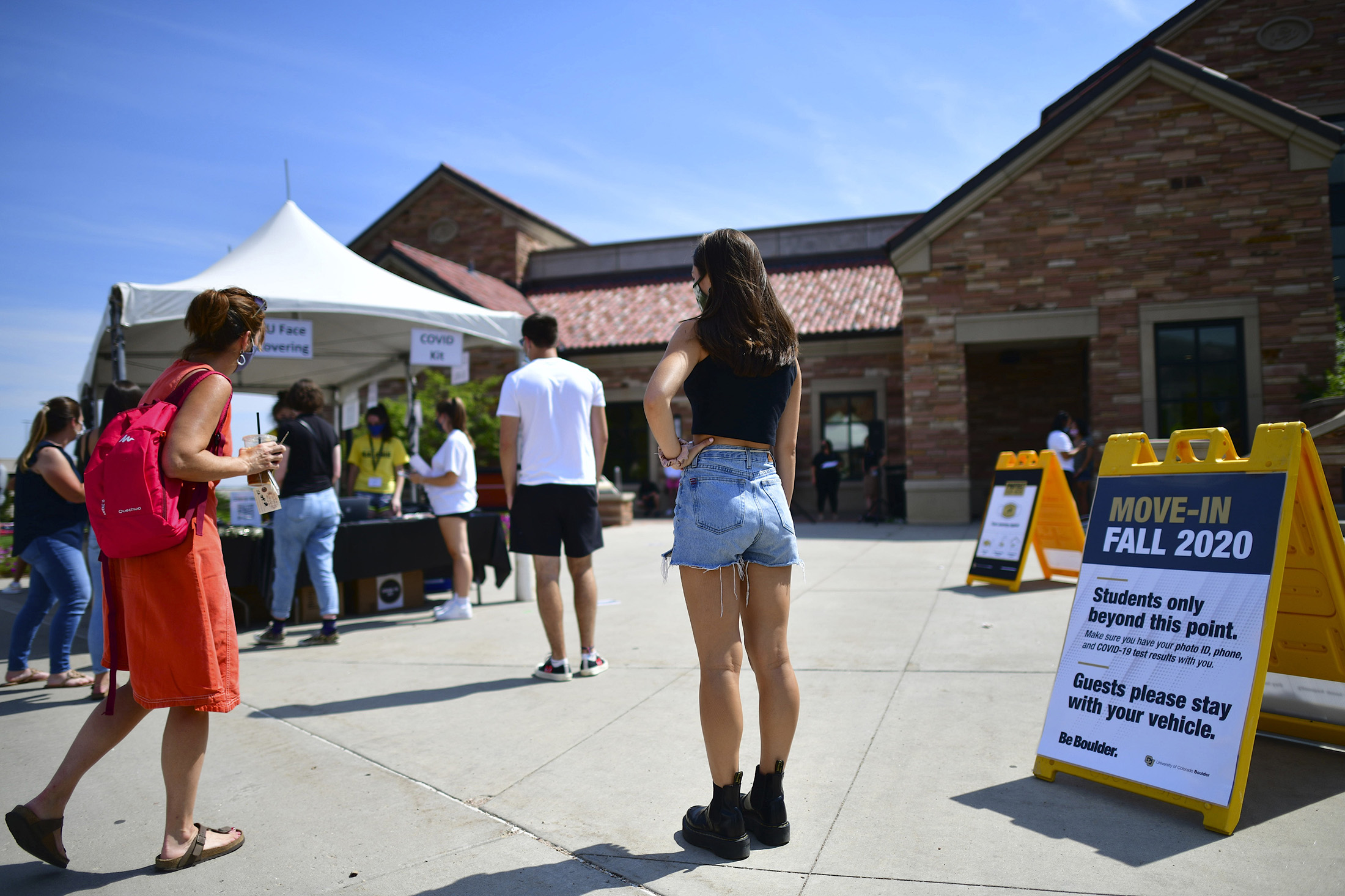 Incoming freshmen wait in line while arriving on campus at University of Colorado Boulder.