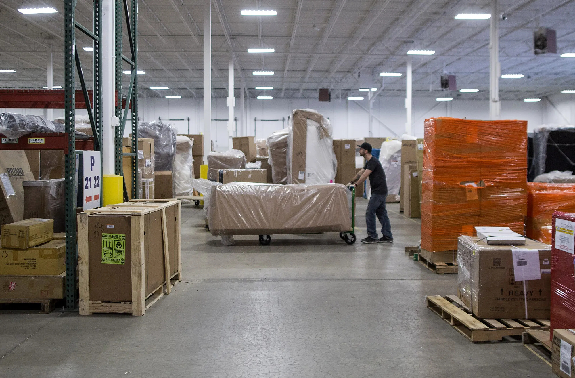 An employee moves a sofa at the Wayfair&nbsp;studio in Westborough, Massachusetts.