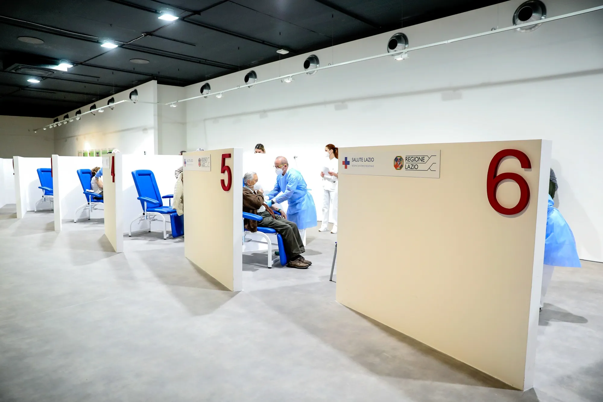 A health worker administers a vaccine to a visitor at a Covid-19 vaccination center in Rome, on March 17.