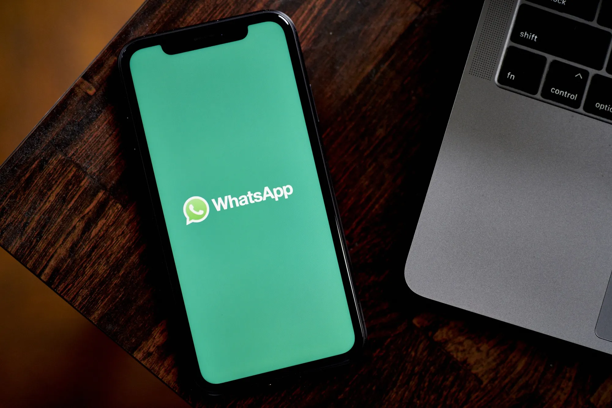 The WhatsApp logo on a smartphone.