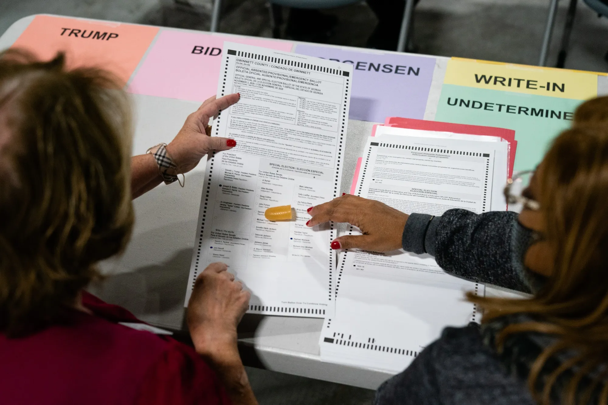 People hand count 2020 Presidential election ballots during an audit at the Gwinnett County Voter Registration office in Lawrenceville, Georgia in Nov. 2020.&nbsp;