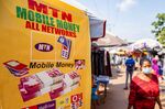 A sign advertising the MTN Group Ltd. mobile money payment service&nbsp;in Accra, Ghana.
