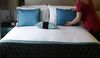 A chambermaid prepares a bed in a guest room in this arranged photograph taken inside a Hotel Indigo hotel, operated by InterContinental Hotels Group Plc, in London, U.K.