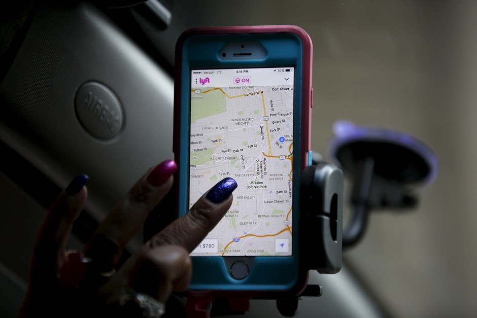 A Lyft driver in California navigates her app. A new UCLA study suggests the service is closing mobility gaps in Los Angeles County. 