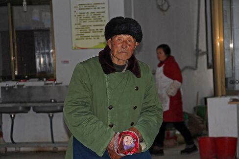 An elderly man stands in one of the rooms at the Jiang Buying Retirement Home in Rudong.